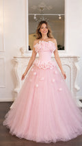 Front view of model wearing the pink 3D rose strapless tulle gown
