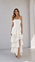 Front view of woman wearing white strapless ruffled tiered maxi dress