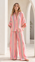 Front view of model wearing pink striped lounge set with wide-leg pants