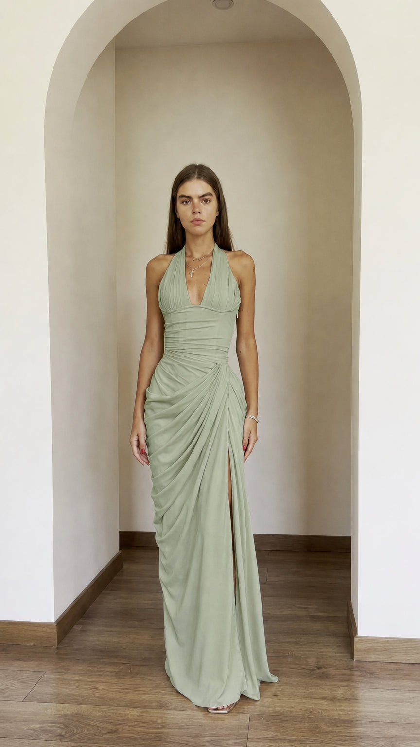 Front view of model wearing sage green halter ruched maxi dress